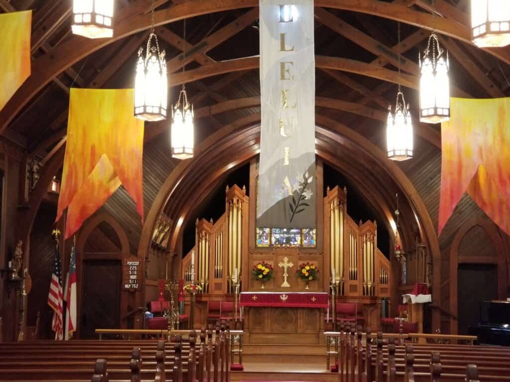 Interior of the Church of the Incarnation with wooden architecture and altar.