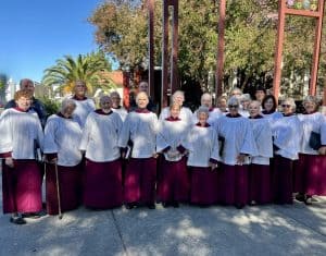 Senior choir members of the Church of the Incarnation in choir robes outside.