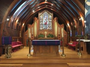 Interior of Church of the Incarnation with altar and stained glass window.